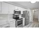 Updated kitchen featuring stainless steel appliances, white subway tile backsplash, and ample cabinet space at 1027 Regency Dr, Acworth, GA 30102