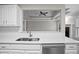 Kitchen featuring white countertops, stainless steel sink, stainless steel dishwasher, and view into living room at 1027 Regency Dr, Acworth, GA 30102
