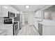 Modern kitchen with stainless steel appliances, subway tile backsplash, white cabinets, and white countertops at 1027 Regency Dr, Acworth, GA 30102