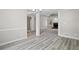 Open-concept living room with tray ceilings, a ceiling fan, and a brick fireplace at 1027 Regency Dr, Acworth, GA 30102