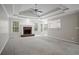 Bright living room with a brick fireplace, neutral carpet, and views into the breakfast nook and kitchen at 1027 Regency Dr, Acworth, GA 30102