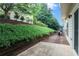 Landscaped backyard with greenery, a concrete patio, and an outdoor grilling area at 1067 Brownstone Dr # 23, Marietta, GA 30008