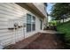 Exterior view of a backyard with a small patio, landscaping, and side of a home at 1067 Brownstone Dr # 23, Marietta, GA 30008