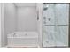 Bathroom featuring tile floors, neutral paint, a tub, and a marble shower at 1067 Brownstone Dr # 23, Marietta, GA 30008