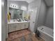 Bathroom featuring double vanities, a soaking tub, and modern fixtures, perfect for relaxation and convenience at 1067 Brownstone Dr # 23, Marietta, GA 30008