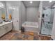 Modern bathroom featuring a soaking tub, walk-in shower, double vanity, and tile floors at 1067 Brownstone Dr # 23, Marietta, GA 30008