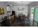 Dining area featuring modern light fixture, seating for four, and access to the outdoor patio at 1067 Brownstone Dr # 23, Marietta, GA 30008