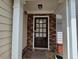 Charming front door with stone accents, a security screen, and decorative features at 1067 Brownstone Dr # 23, Marietta, GA 30008