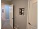 Hallway featuring neutral paint, a picture rail, and two white doors at 1067 Brownstone Dr # 23, Marietta, GA 30008