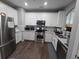 Well-lit kitchen boasts stainless steel appliances, white cabinets, and ample counter space at 1067 Brownstone Dr # 23, Marietta, GA 30008