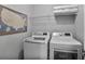 Well-lit laundry room features a modern washer and dryer and shelving for storage at 1067 Brownstone Dr # 23, Marietta, GA 30008