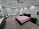 Bright main bedroom with a ceiling fan, neutral paint, and a comfortable bed, creating a relaxing atmosphere at 1067 Brownstone Dr # 23, Marietta, GA 30008