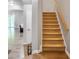 Carpeted staircase with wood railing leading to the upper level of the home at 1067 Brownstone Dr # 23, Marietta, GA 30008