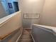 Stairwell with carpeted steps and a wooden handrail, artwork and well-lit by natural light at 1067 Brownstone Dr # 23, Marietta, GA 30008