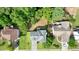 Aerial view showcasing a home with well-maintained lawn, spacious backyard, and a deck, surrounded by mature trees at 2004 Spicers Ln, Woodstock, GA 30189