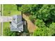 Aerial view of a backyard with a deck and outdoor seating, surrounded by a green lawn and mature trees at 2004 Spicers Ln, Woodstock, GA 30189