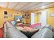 Finished basement with wood ceiling, comfortable seating, television, and access to other rooms at 2004 Spicers Ln, Woodstock, GA 30189