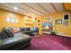 Basement featuring wood ceiling, recessed shelving, modern TV, and comfortable sectional couch at 2004 Spicers Ln, Woodstock, GA 30189
