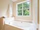 Bathroom with large tub under a large window, plus a towel inset next to the tub at 2004 Spicers Ln, Woodstock, GA 30189