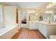 Bathroom features a soaking tub, double sink vanity, and access to the Primary bedroom and walk-in closet at 2004 Spicers Ln, Woodstock, GA 30189