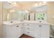 This bathroom features a double vanity, a large mirror, and lots of storage with drawers and cabinets at 2004 Spicers Ln, Woodstock, GA 30189