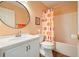Bathroom with a white vanity, a round mirror, and a colorful shower curtain at 2004 Spicers Ln, Woodstock, GA 30189