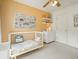 Bright Bedroom featuring a crib, shelves, and natural light at 2004 Spicers Ln, Woodstock, GA 30189