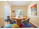 Dining room features a round wood table and bright colorful carpet at 2004 Spicers Ln, Woodstock, GA 30189