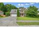 Charming two-story home featuring a stone and vinyl facade, two-car garage, and well-manicured lawn at 2004 Spicers Ln, Woodstock, GA 30189