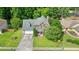 Charming two-story home features a well-manicured lawn, two-car garage, and inviting front porch, surrounded by mature trees at 2004 Spicers Ln, Woodstock, GA 30189