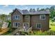 Exterior view of a two-story home with a deck overlooking the backyard at 2004 Spicers Ln, Woodstock, GA 30189