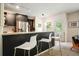 Modern kitchen featuring dark cabinets, granite countertops, stainless steel appliances, and bar seating at 2004 Spicers Ln, Woodstock, GA 30189