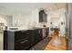 Kitchen with granite countertops, stainless appliances, and sleek dark cabinets at 2004 Spicers Ln, Woodstock, GA 30189
