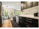 Kitchen with stainless appliances, dark cabinets, granite counters, and a door to the outside at 2004 Spicers Ln, Woodstock, GA 30189