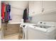 Functional laundry room with a washer, dryer, and storage cabinets at 2004 Spicers Ln, Woodstock, GA 30189