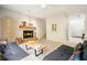 Cozy living room featuring a fireplace, staircase, and stylish furnishings at 2004 Spicers Ln, Woodstock, GA 30189