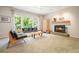 Cozy living room featuring a fireplace, large windows, and stylish furnishings at 2004 Spicers Ln, Woodstock, GA 30189