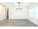 Bright dining room with modern chandelier, wainscoting and light gray flooring at 2117 Ella Springs Dr, Covington, GA 30014