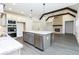 Modern kitchen featuring a large island, stainless steel appliances, and a fireplace with exposed beams at 2117 Ella Springs Dr, Covington, GA 30014