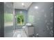 Modern bathroom featuring a floating vanity, stand up shower and a large window at 2575 Flagstone Se Dr, Atlanta, GA 30316