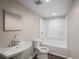 Bathroom with white sink, toilet, and tub with shower head at 2575 Flagstone Se Dr, Atlanta, GA 30316