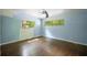 Bedroom with blue walls, a ceiling fan, hardwood floors and a window overlooking the trees at 2575 Flagstone Se Dr, Atlanta, GA 30316