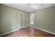 This bedroom has hardwood floors, a door, and an open door way at 2575 Flagstone Se Dr, Atlanta, GA 30316