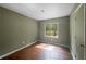 Bedroom with hardwood floors, a window, and neutral-colored walls with white trim at 2575 Flagstone Se Dr, Atlanta, GA 30316