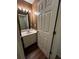 Cozy bathroom with single sink vanity, mirror, and light fixture at 3613 Tinsley Sw Way, Atlanta, GA 30331