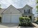Inviting home with a two-car garage, attractive facade, and beautiful flowering bushes in the front yard at 3613 Tinsley Sw Way, Atlanta, GA 30331