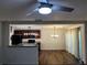 Well-designed kitchen featuring dark cabinetry, stainless steel appliances, and an adjacent dining area with modern lighting at 3613 Tinsley Sw Way, Atlanta, GA 30331