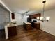 Functional kitchen with an island, dark cabinets, and stainless steel appliances, complemented by an adjacent dining space at 3613 Tinsley Sw Way, Atlanta, GA 30331