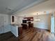 Open kitchen and dining area with dark cabinetry, modern appliances, and a seamless flow for entertaining guests at 3613 Tinsley Sw Way, Atlanta, GA 30331