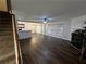 Spacious living room with hardwood floors, fireplace, and open layout leading to the kitchen and dining area at 3613 Tinsley Sw Way, Atlanta, GA 30331